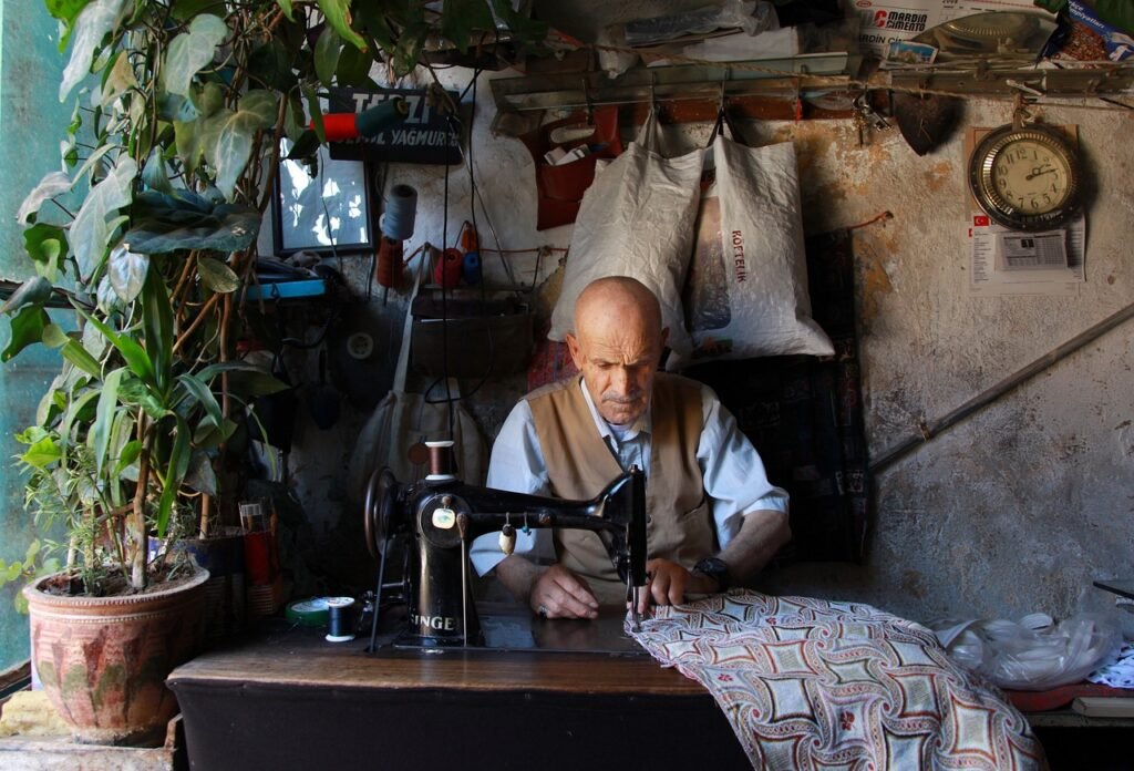 A man sewing a suit.