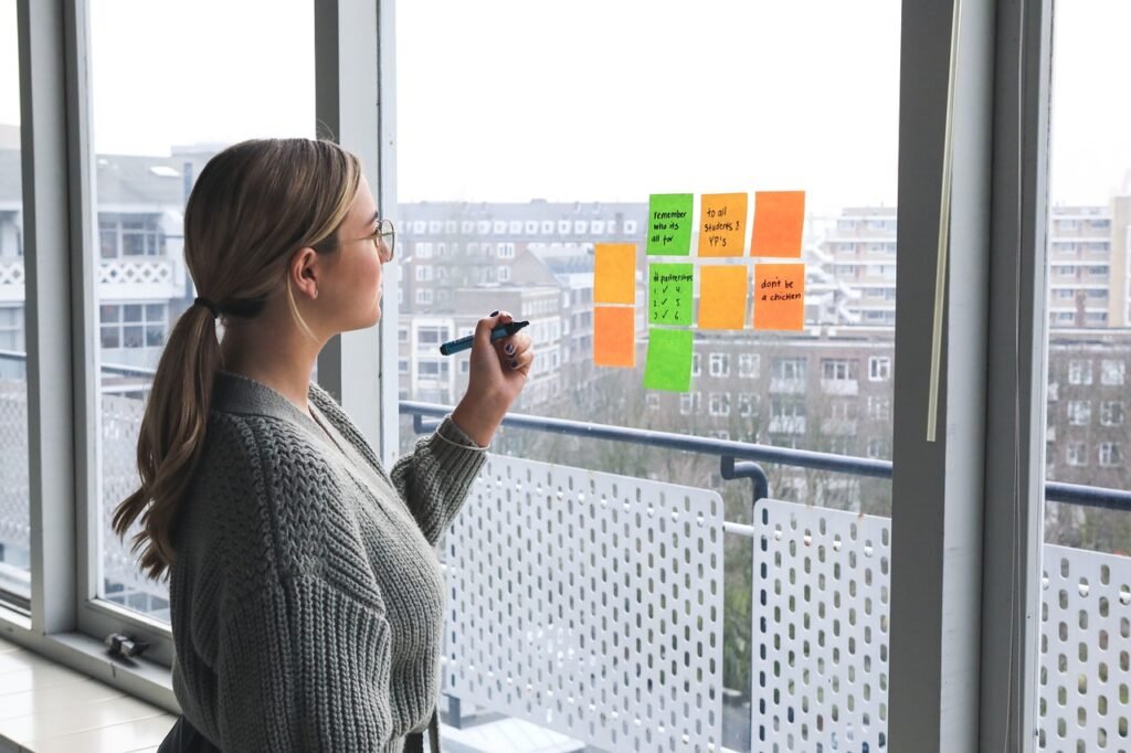 Women writing on post-it notes.